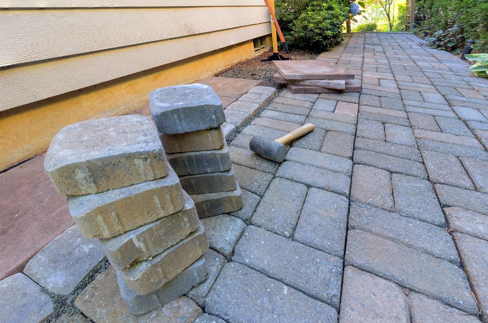 paver-repair-with-a-hammer